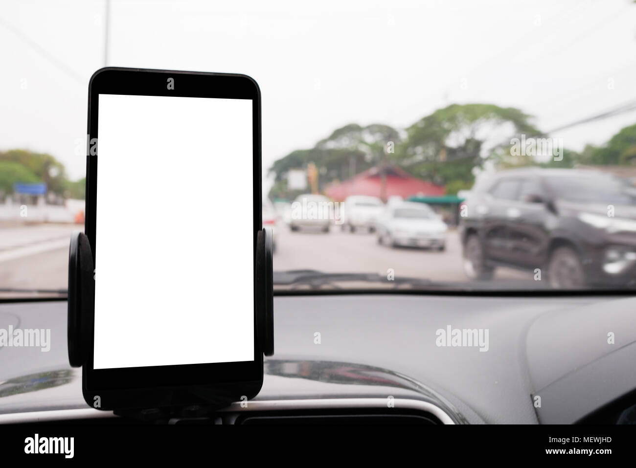 Use your smartphone in car to get GPS directions to your destination through the village. Smartphone is blank Stock Photo