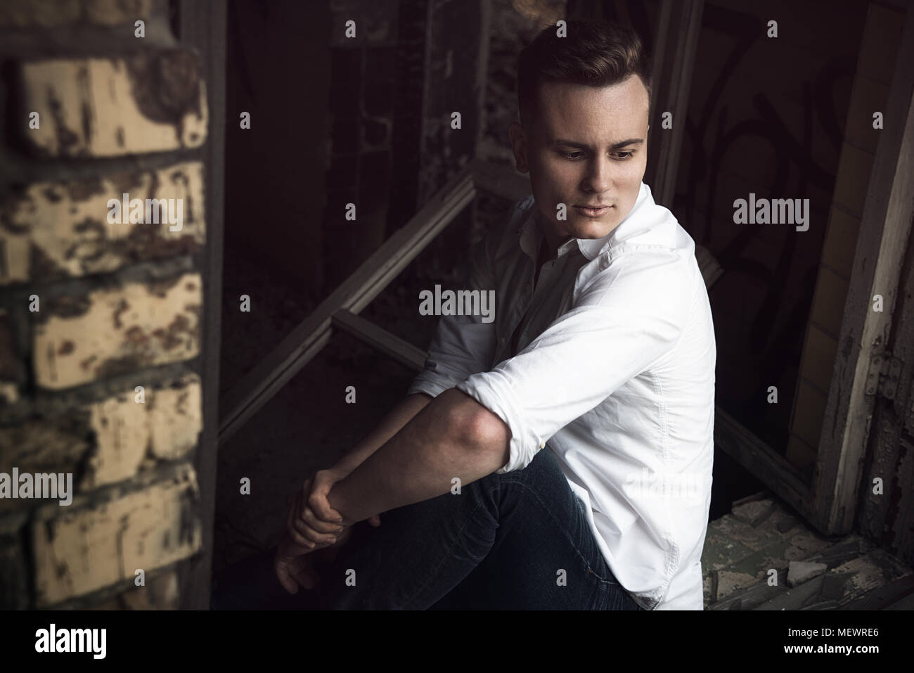brutal man posing in the abandoned place Stock Photo