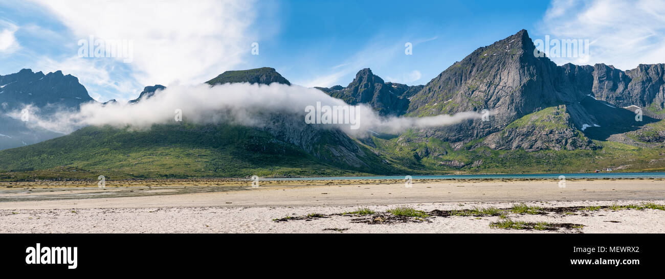 Scenic mountain landscape with low clouds at sunny summer day in Lofoten Islands, Norway Stock Photo