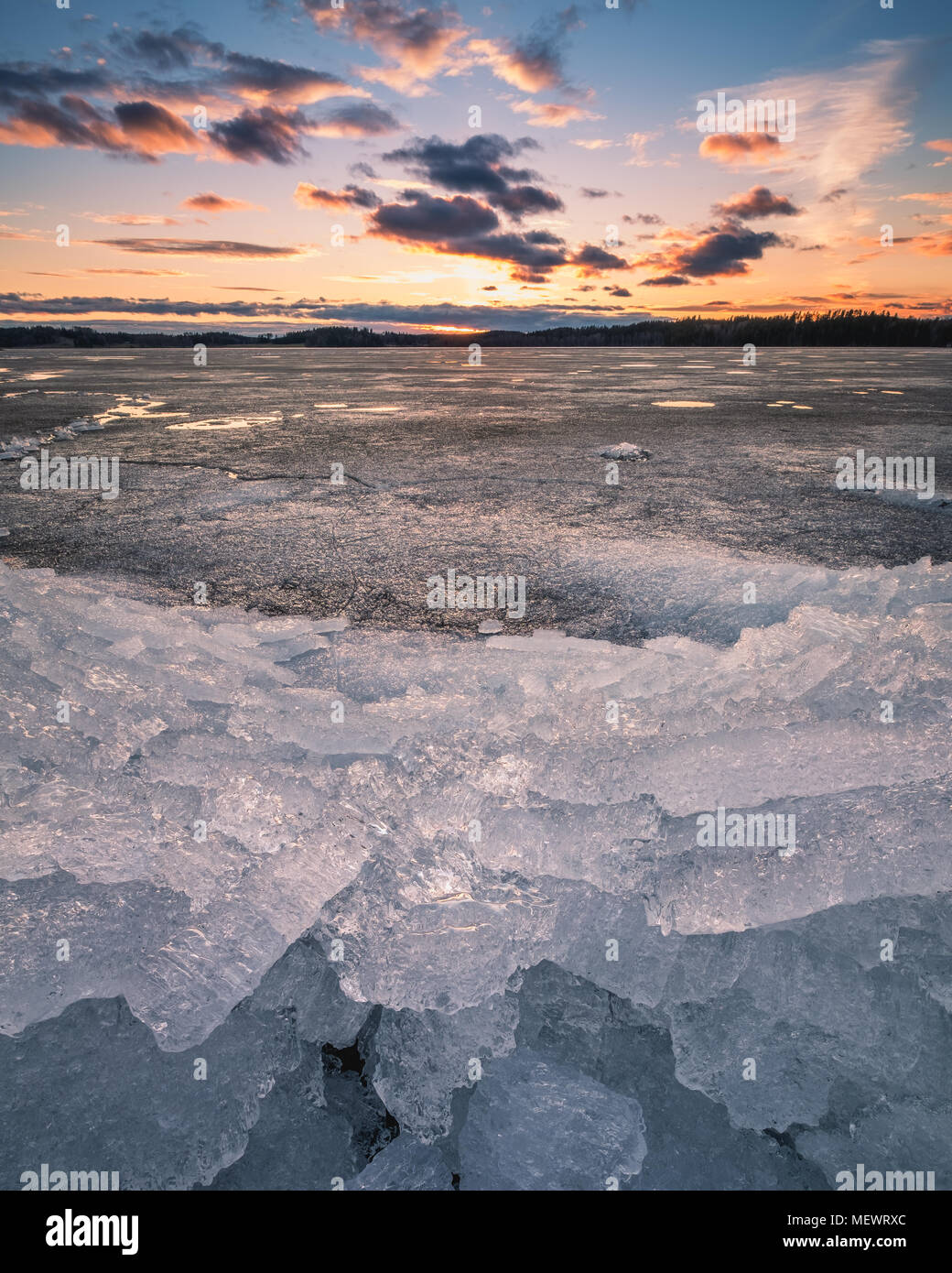 Scenic spring landscape with melting ice and sunset at evening time in Finland Stock Photo