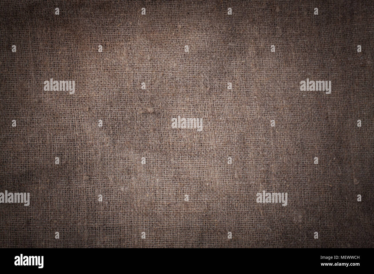 Old stained brown horizontal creasy burlap texture. Stock Photo