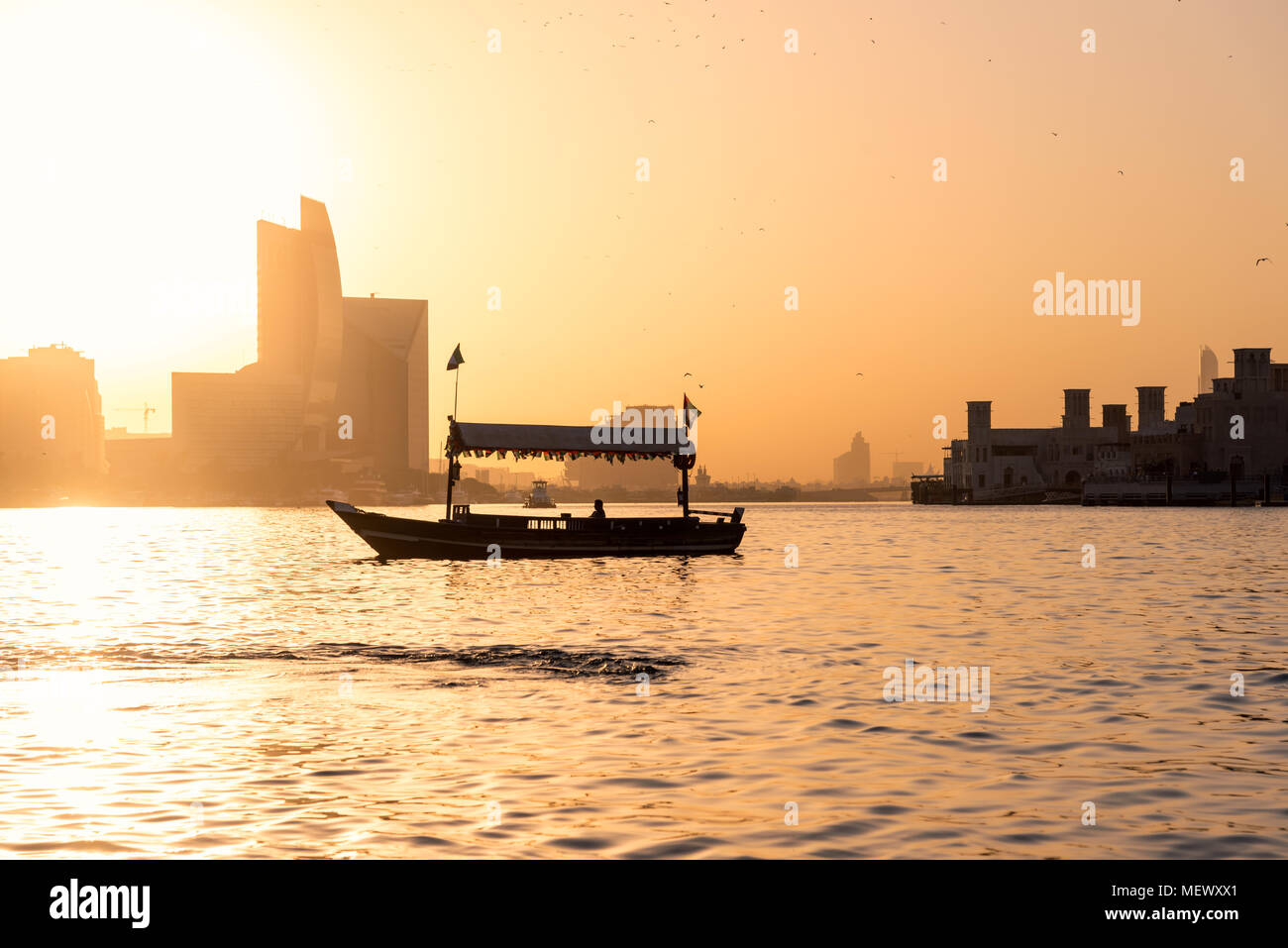 Sunset view and Boat floating in old town of Dubai city, Deira, Dubai, United Arab Emirates Stock Photo