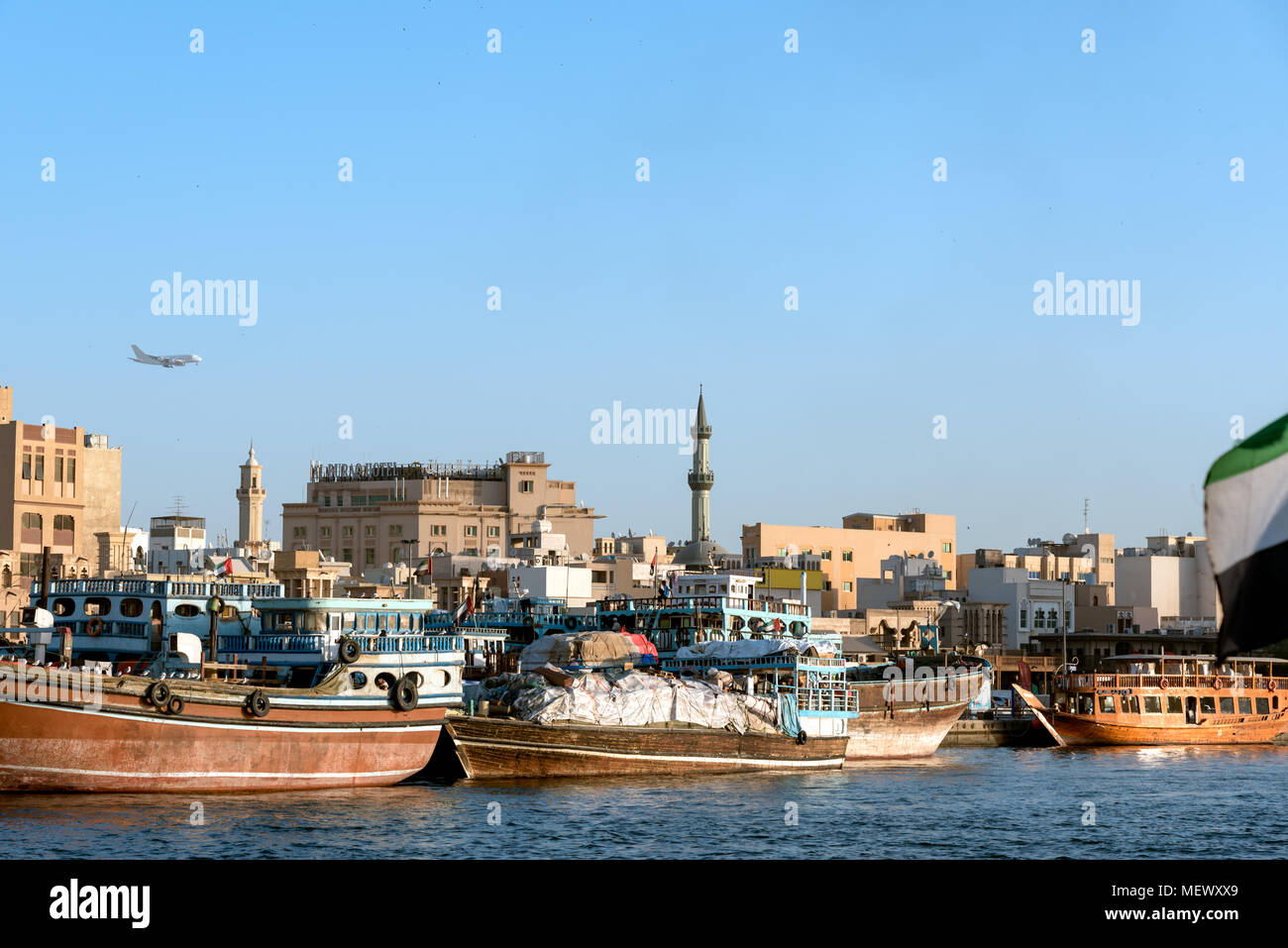 Dhows old wooden sailing vessels are docked along the Deira side of Dubai Creek Stock Photo
