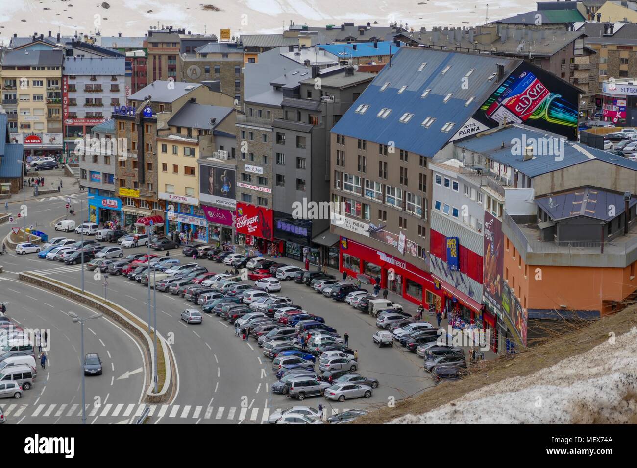 Shops and parked cars at Pas de la Casa, Andorra, at the end of winter Stock Photo Alamy