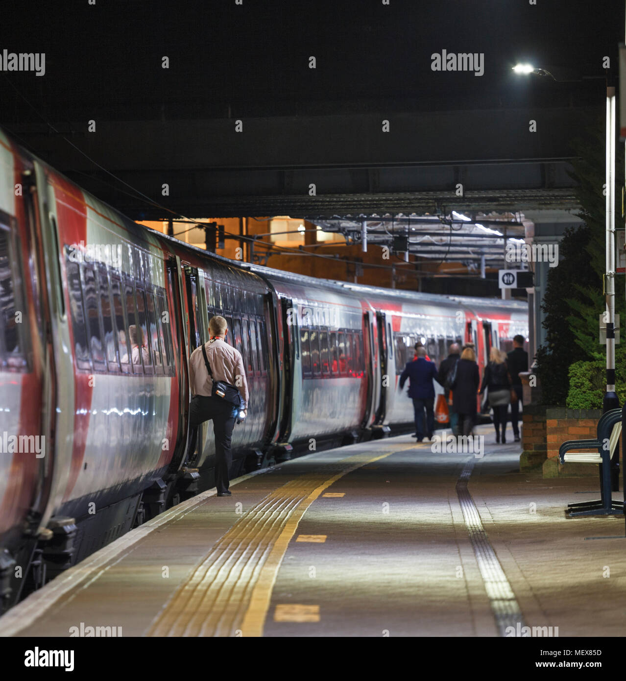The conductor of a late night Virgin Trains east coast train waiting to  close the doors at Berwick Upon Tweed station as passengers leave Stock  Photo - Alamy