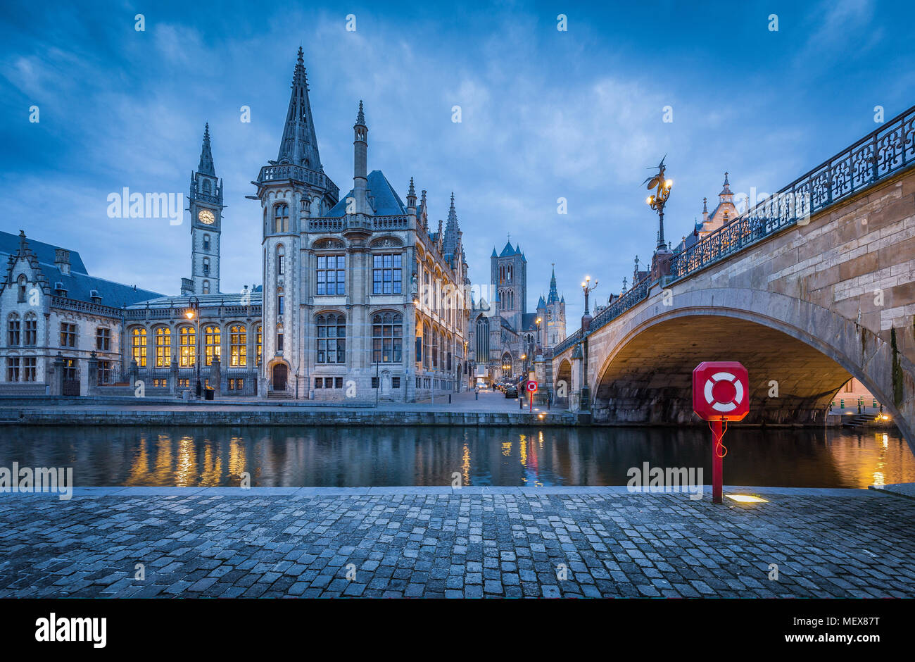 Panoramic view of famous Graslei in the historic city center of Ghent illuminated in beautiful post sunset twilight during blue hour at dusk with Leie Stock Photo