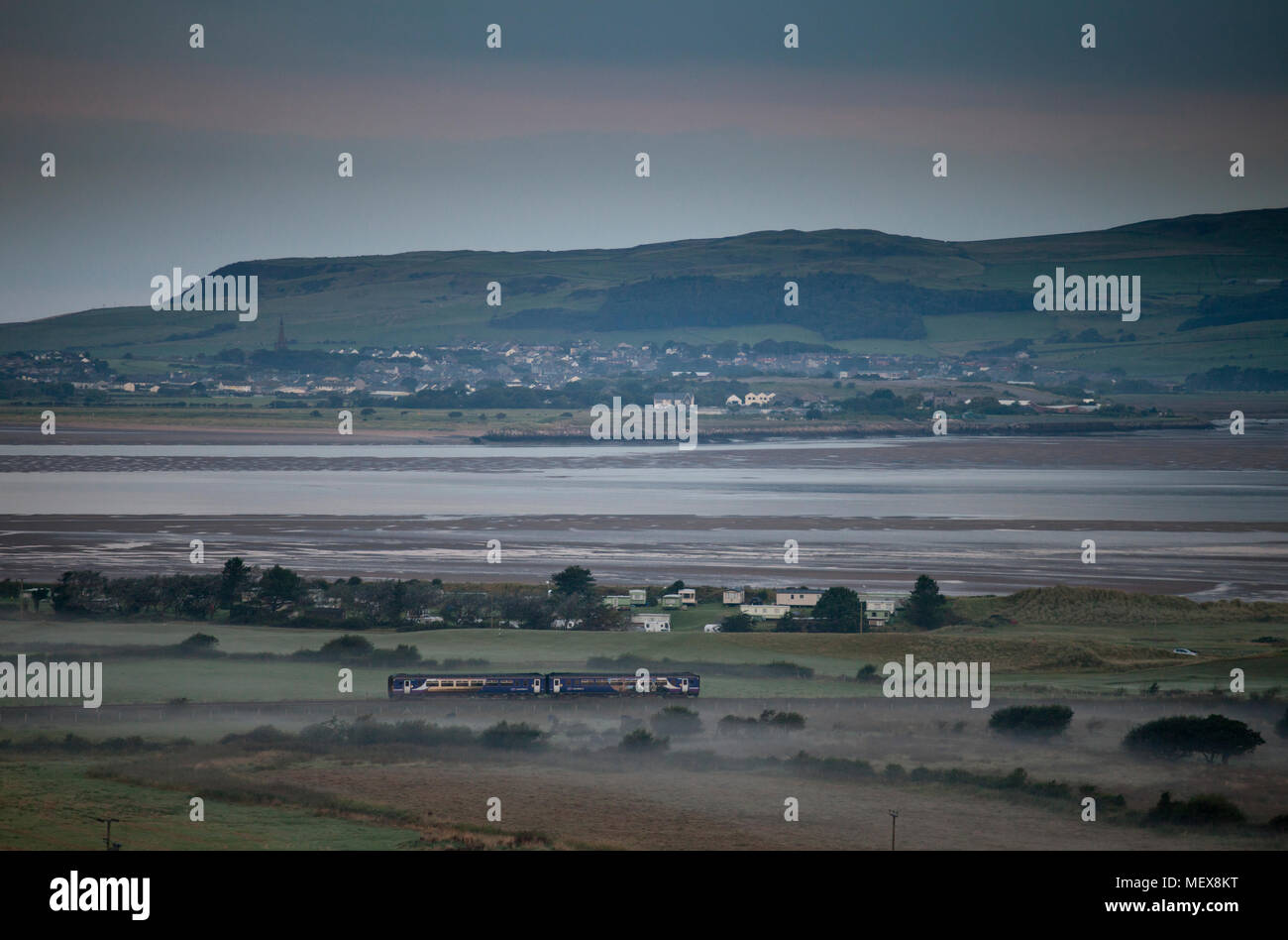 A Northern rail class 156 sprinter train passing the Duddon estuary at