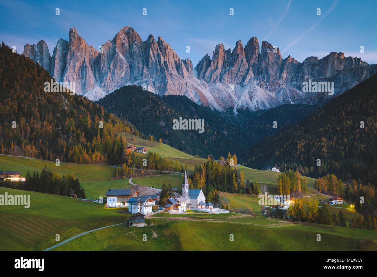 Beautiful view of idyllic mountain scenery in the Dolomites with famous Santa Maddelana mountain village in beautiful golden evening light at sunset Stock Photo