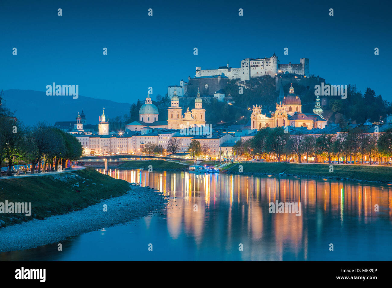 Twilight view of the historic city of Salzburg reflecting in beautiful Salzach river during blue hour at dusk in summer, Salzburg Land, Austria Stock Photo