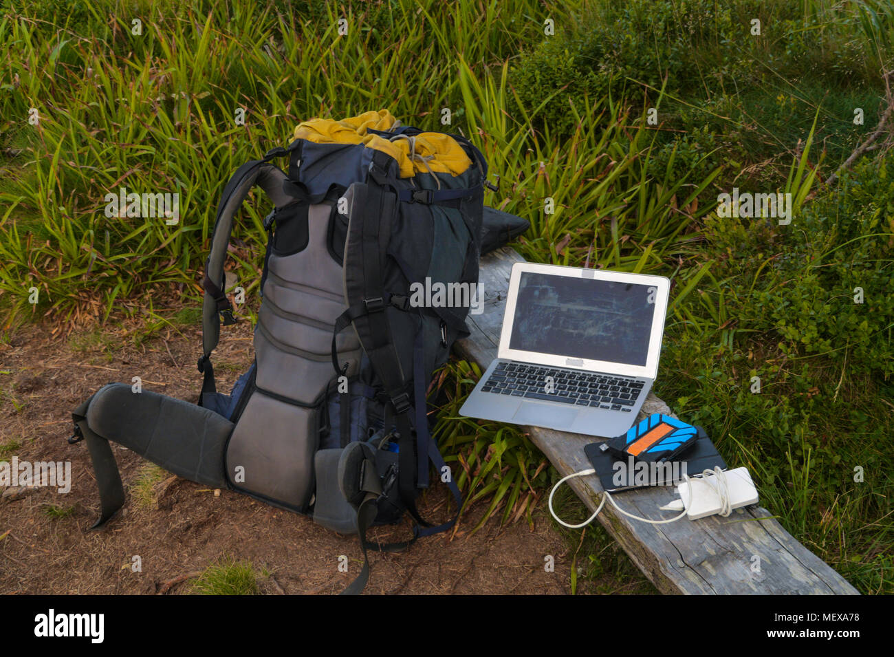 portable technology, solar panel, tablet, laptop and backpack in a