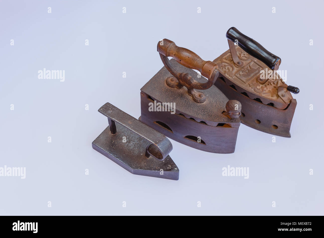 three old irons made of castiron Stock Photo Alamy
