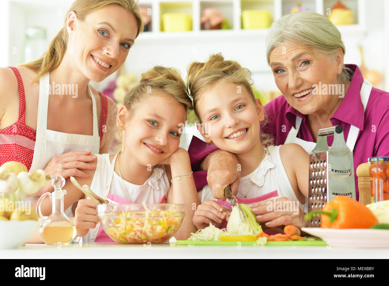 Mom and daughters cook Stock Photo Alamy