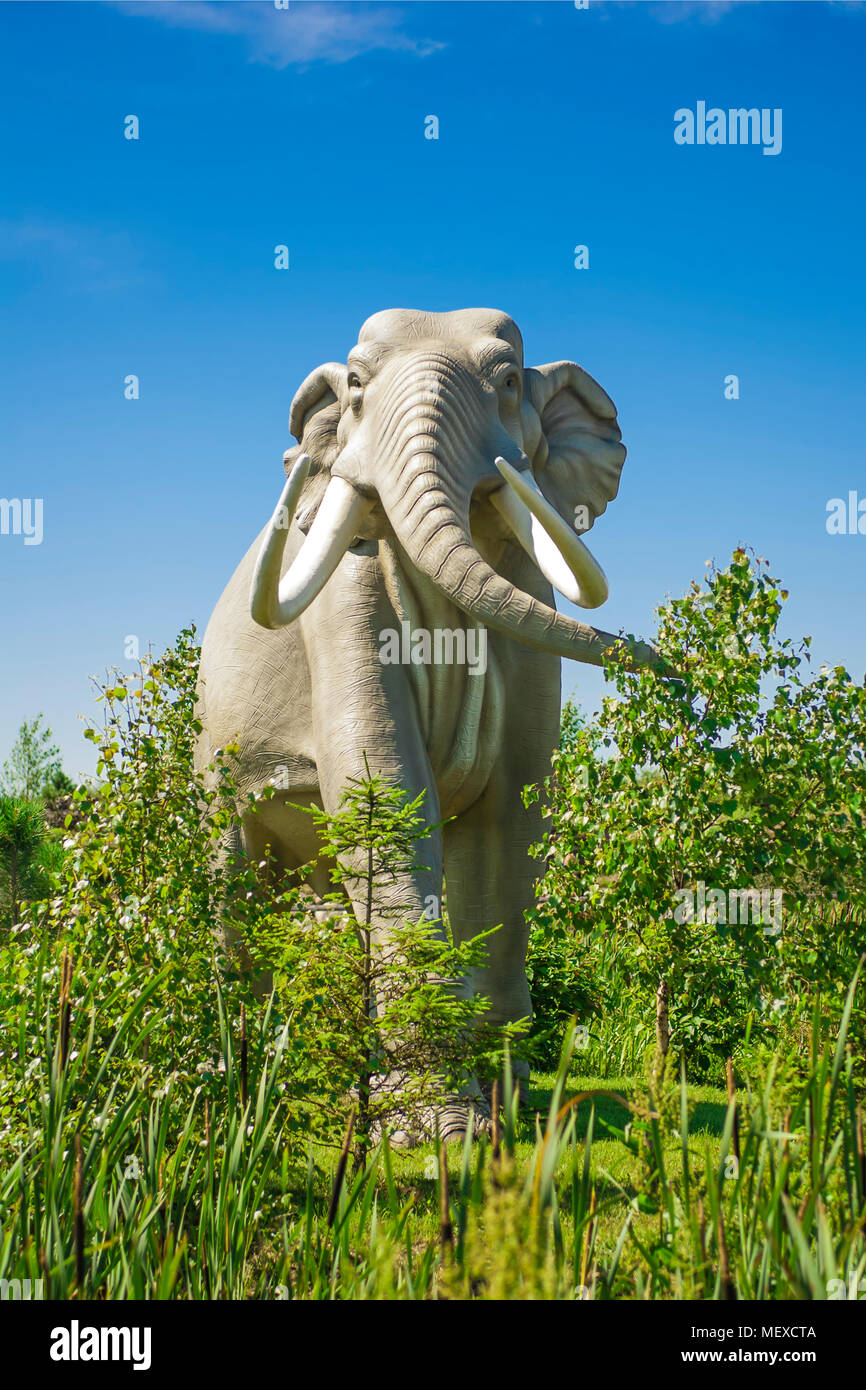 Sculpture of prehistoric elephant living in forest. Stock Photo