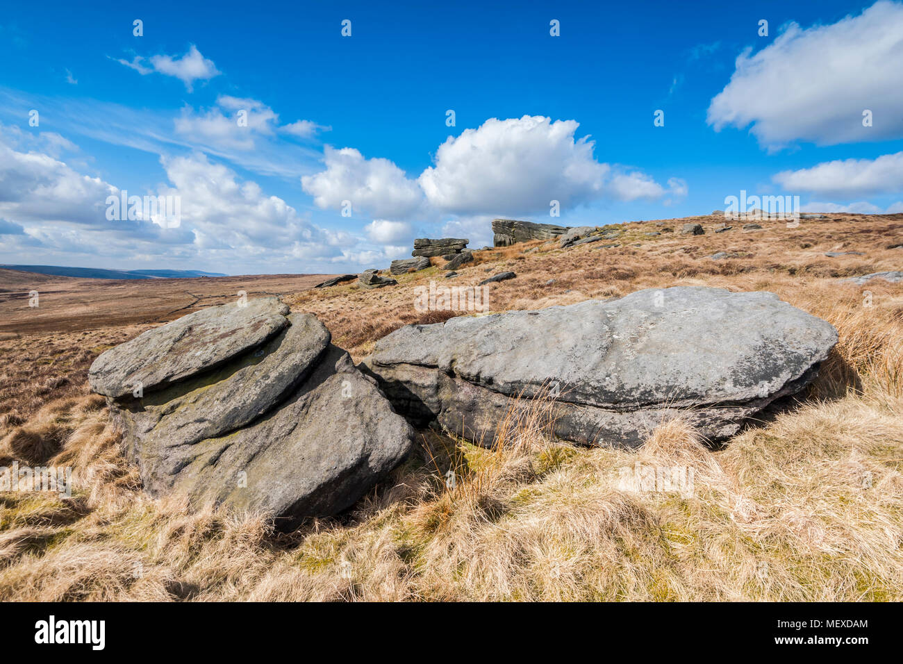 Broken millstone grit boulders scattered on Yorkshire moorland Stock Photo