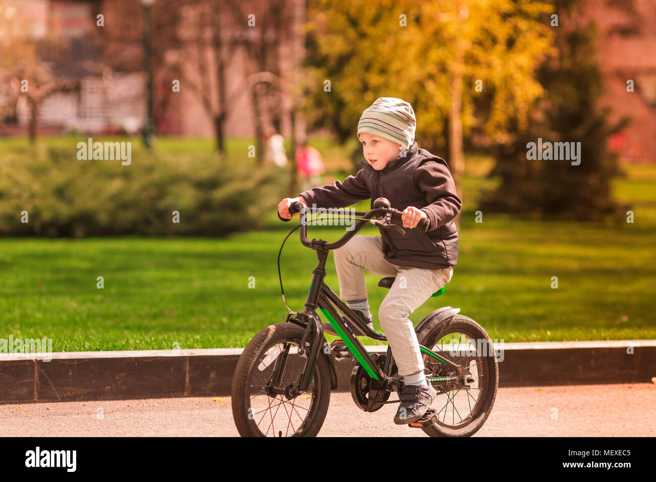 Happy four years old boy learning how to ride a bike. First riding