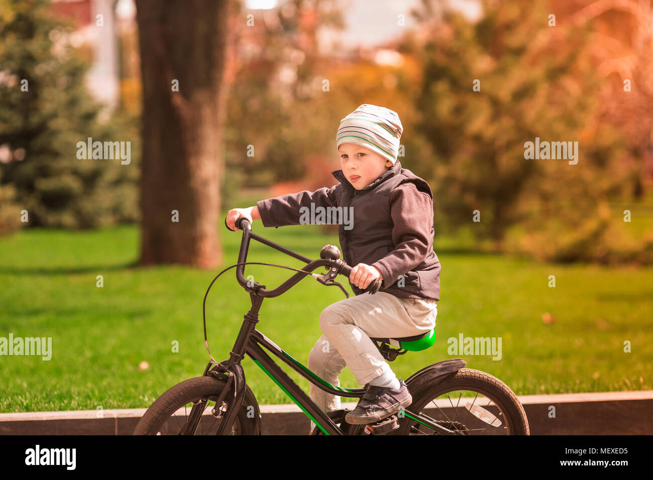 Happy four years old boy learning how to ride a bike. First riding