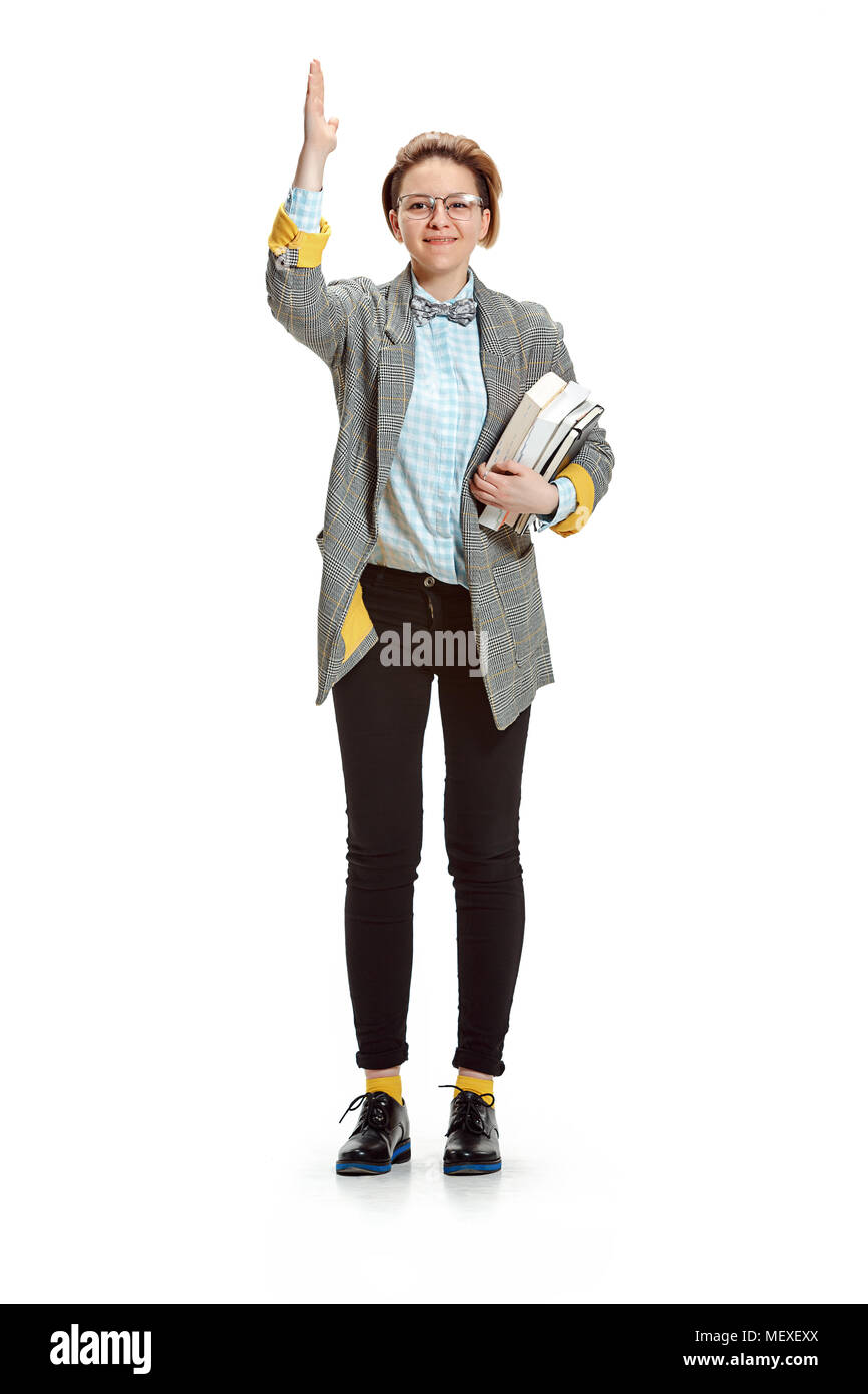 Full length portrait of a happy smiling female student holding books ...