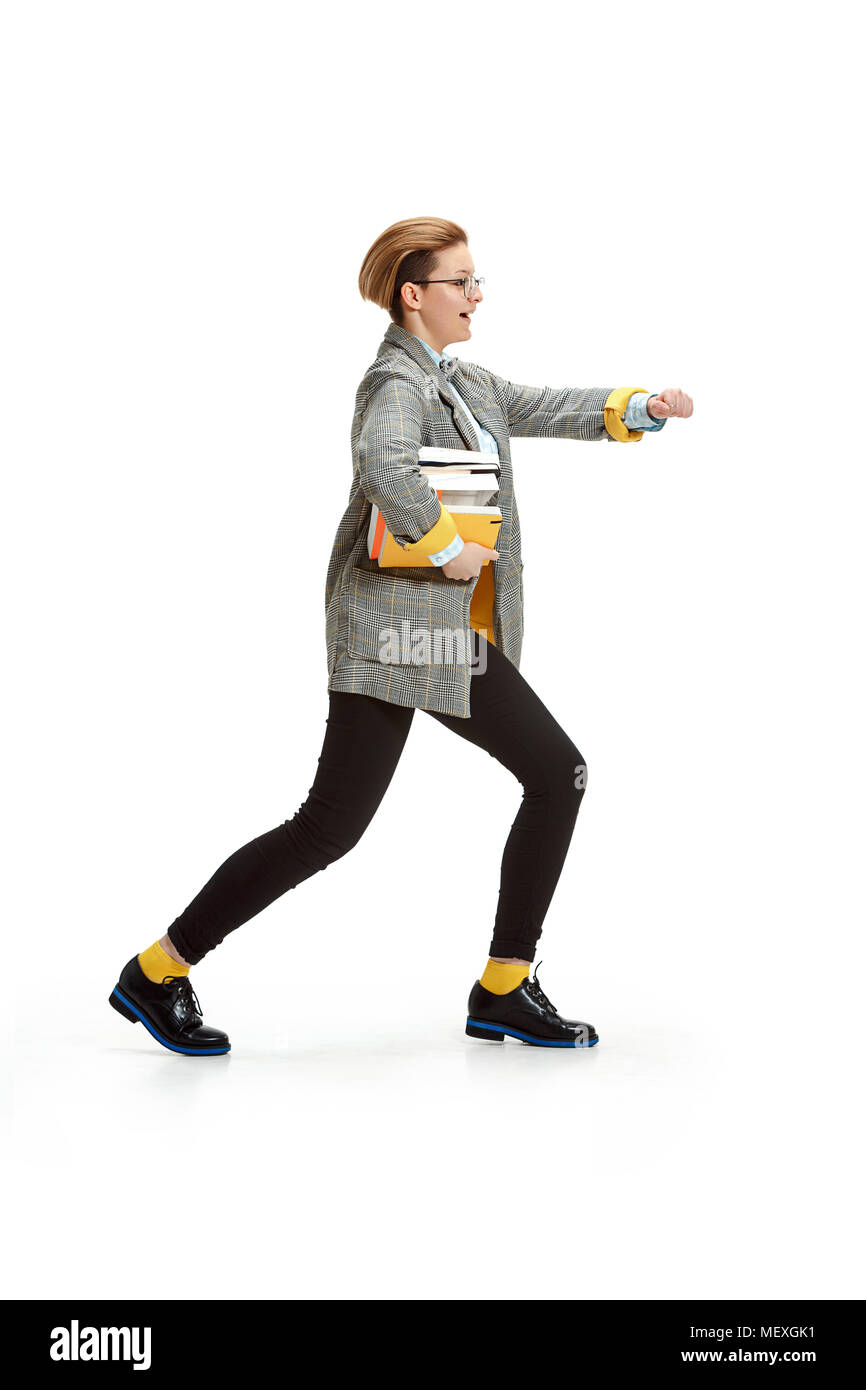 Full length portrait of a happy smiling female student holding books ...