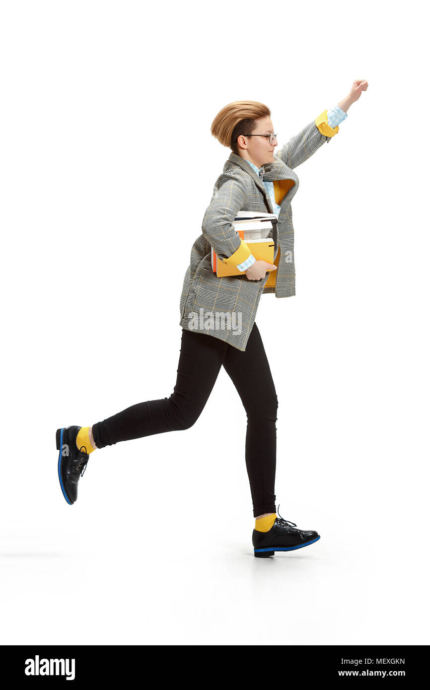 Full length portrait of a happy smiling female student holding books ...