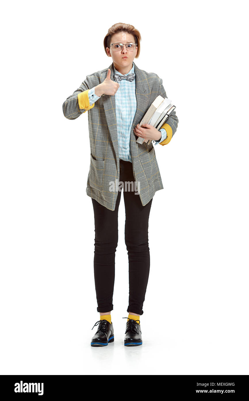Full length portrait of a surprised female student holding books ...