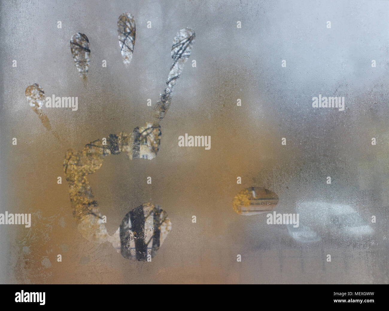 Close-up of the big male left hand print on the window, foggy autumn morning background Stock Photo