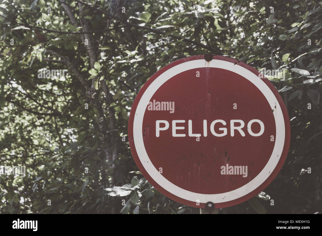 Photograph of a warning danger sign in spanish Stock Photo Alamy