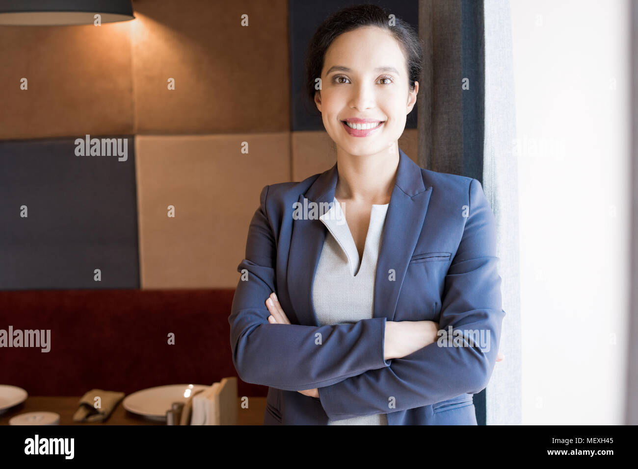 Cheerful successful female restaurateur Stock Photo