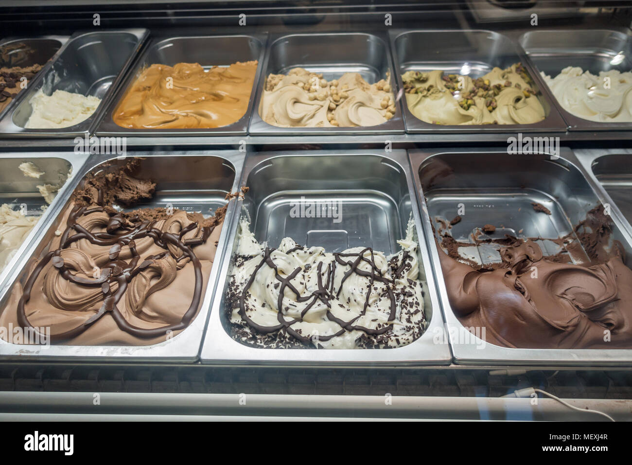Trays containing different flavours of ice cream. Stock Photo
