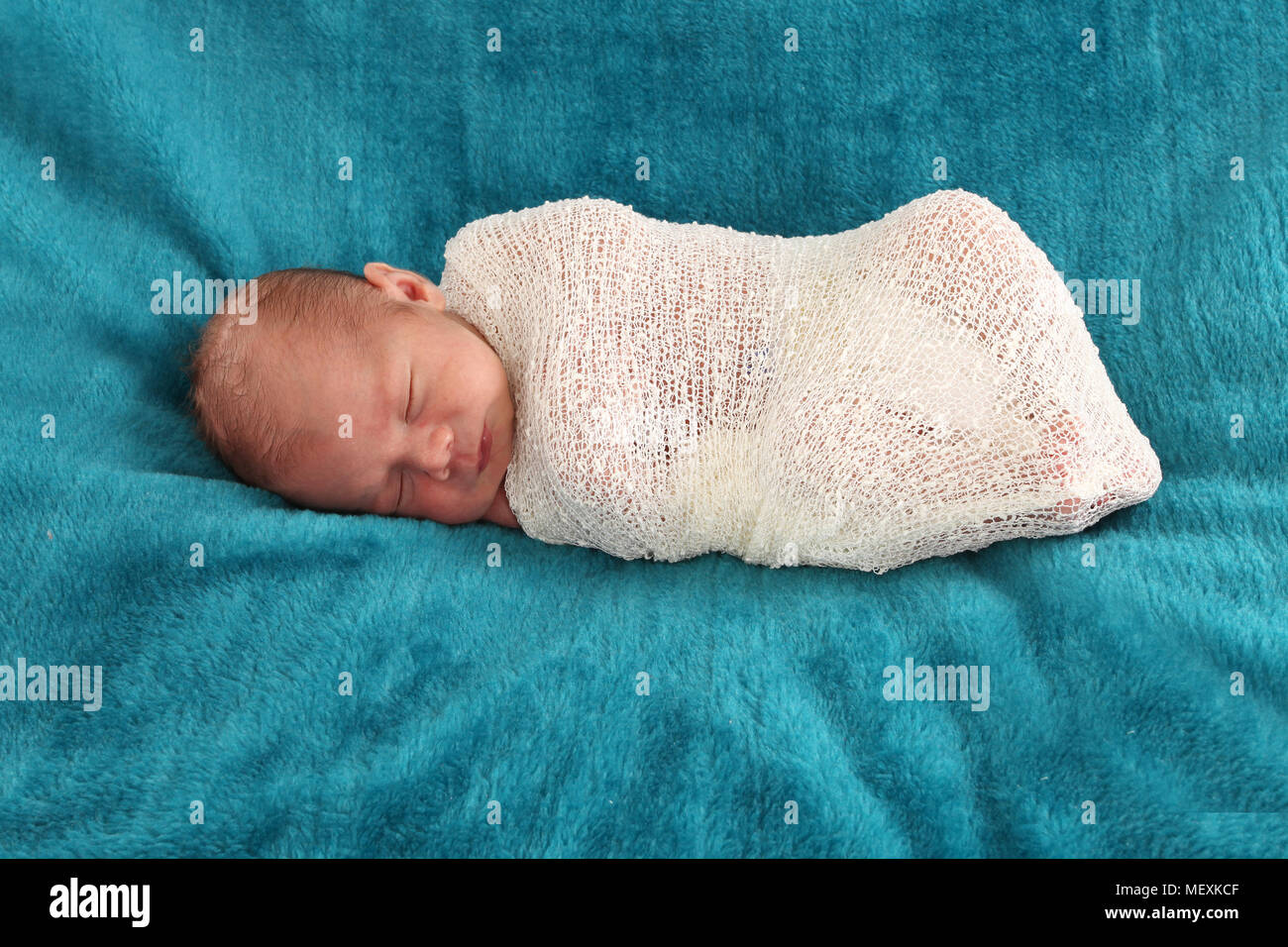 1 week old baby boy, swaddled baby wrap Stock Photo Alamy