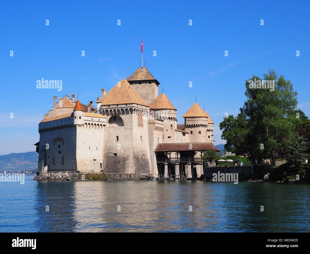 Scenery of medieval Chateau de Chillon at Lake Geneva in Montreux city at Canton of Vaud in Switzerland, landscapes of alpine Lac Leman, clear blue sk Stock Photo