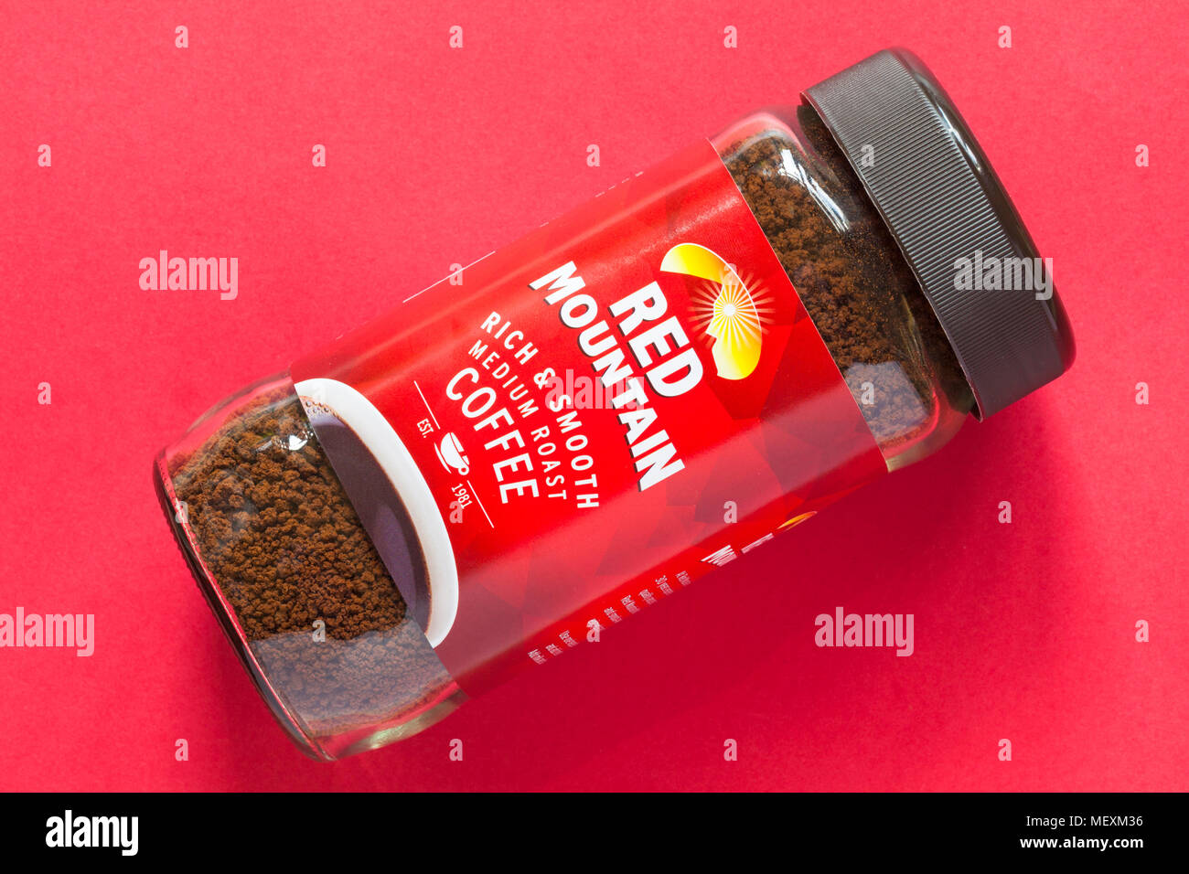 Jar of Red Mountain rich & smooth medium roast coffee isolated on red background Stock Photo