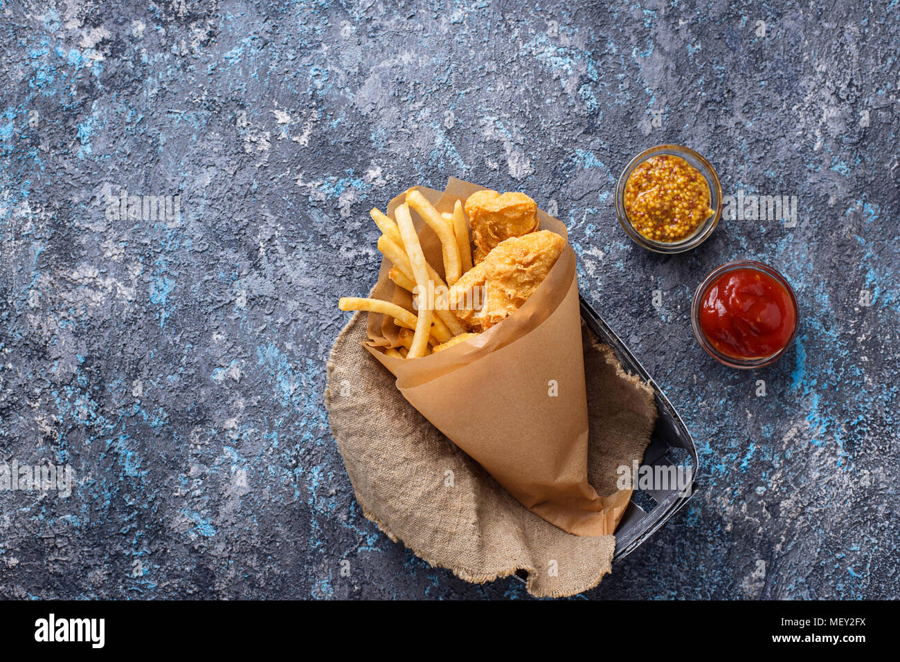 Fish and chips with tomato sauce and mustard Stock Photo Alamy
