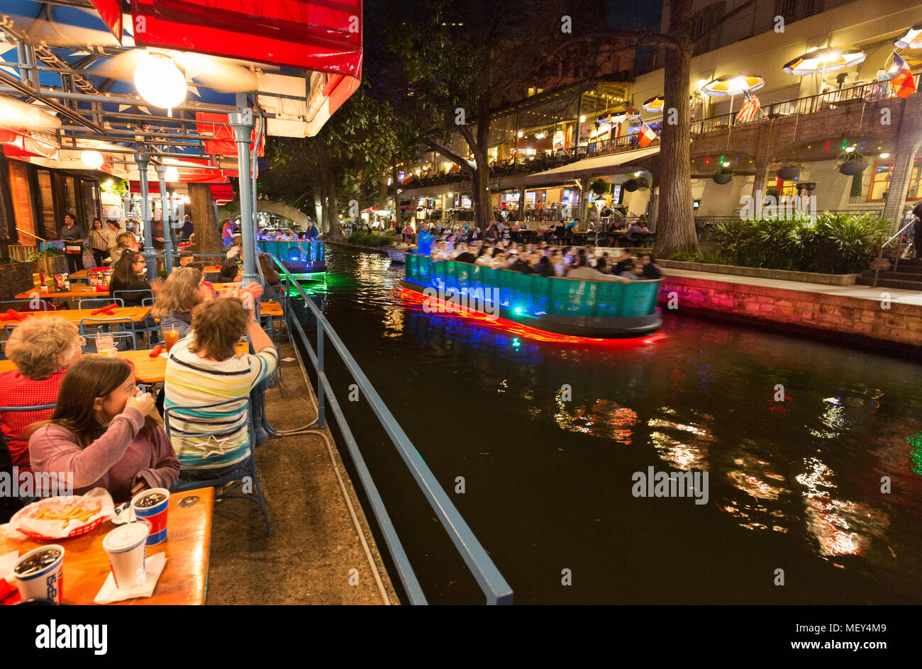 San Antonio Texas - San Antonio River Walk at night - people in restaurants and on boats; San Antonio, Texas USA Stock Photo