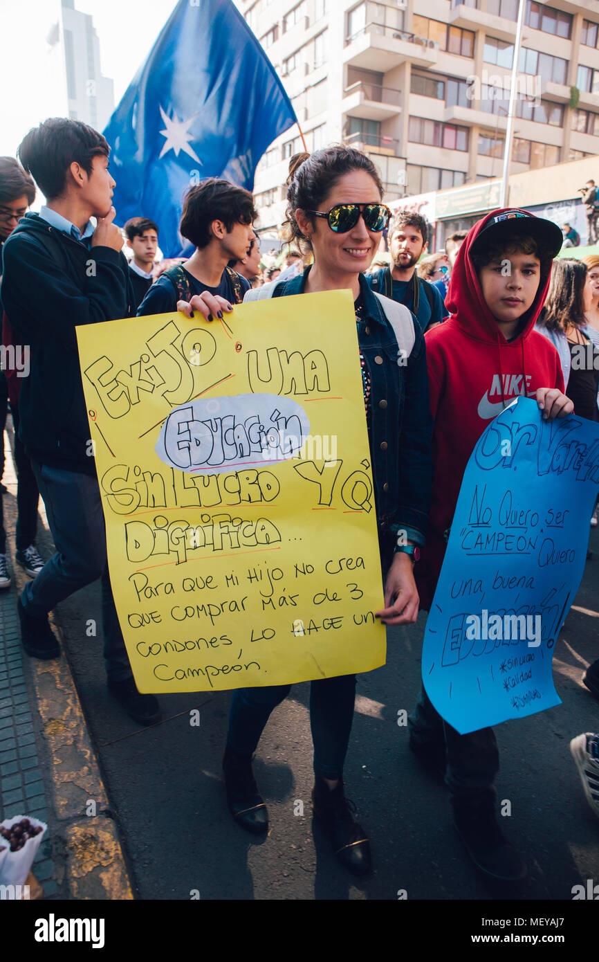 Santiago, Chile - April 19, 2018: Mother and son marched through Santiago's streets, demanding an end to the Profit in the Education Stock Photo