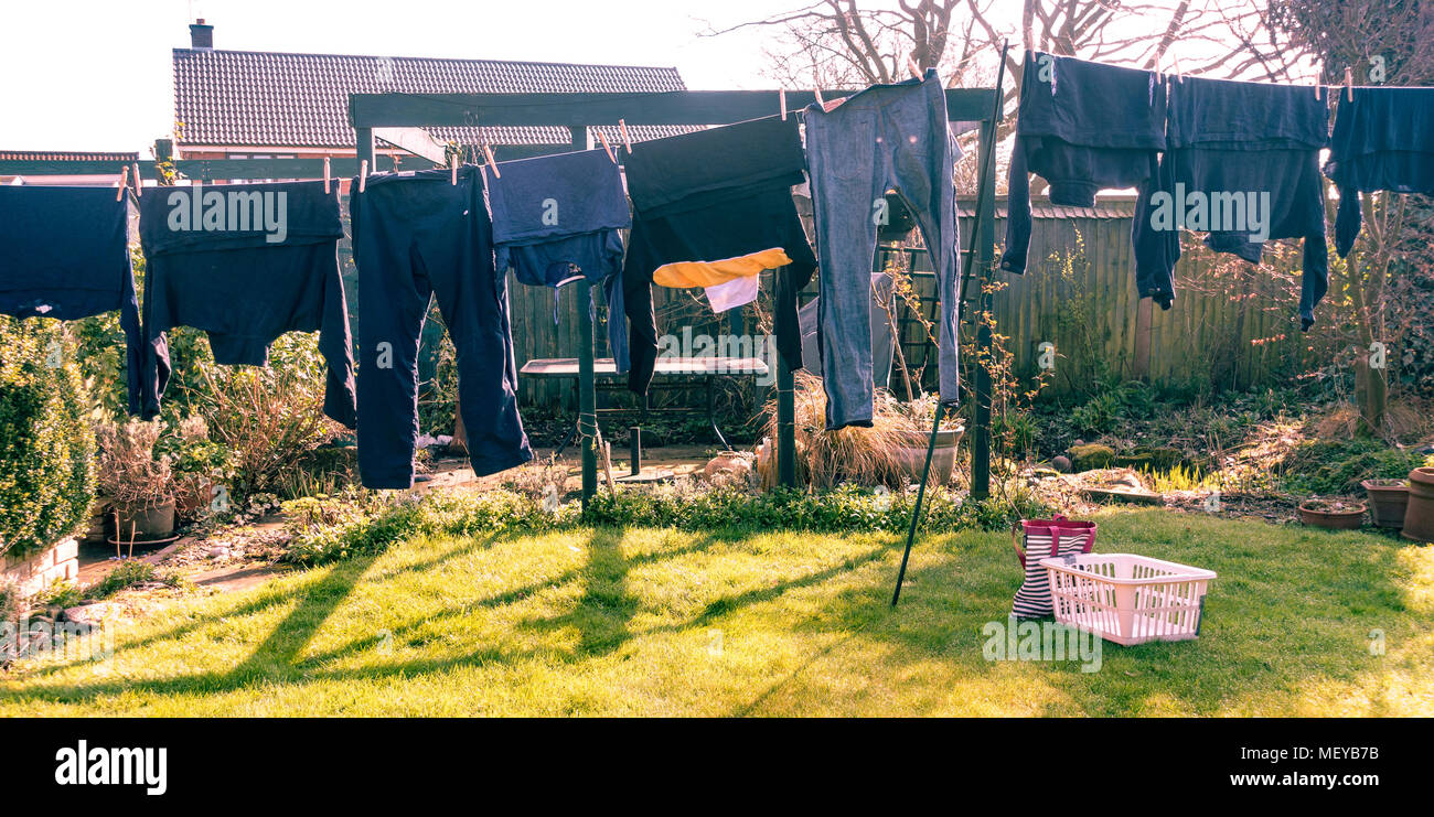 Clothes hanging out to dry on a washing line in a back garden. Stock Photo