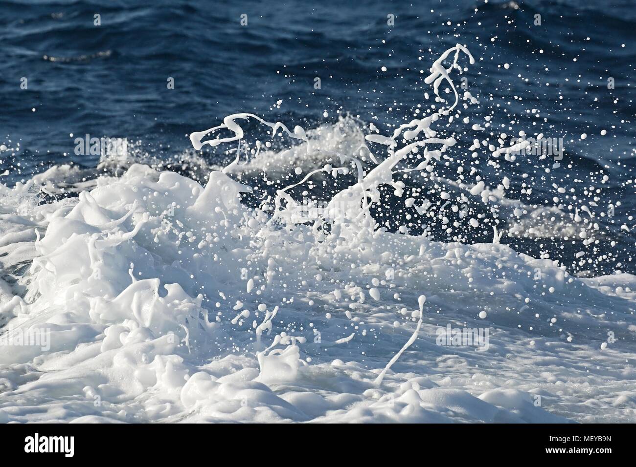 Waves hitting shore Stock Photo - Alamy