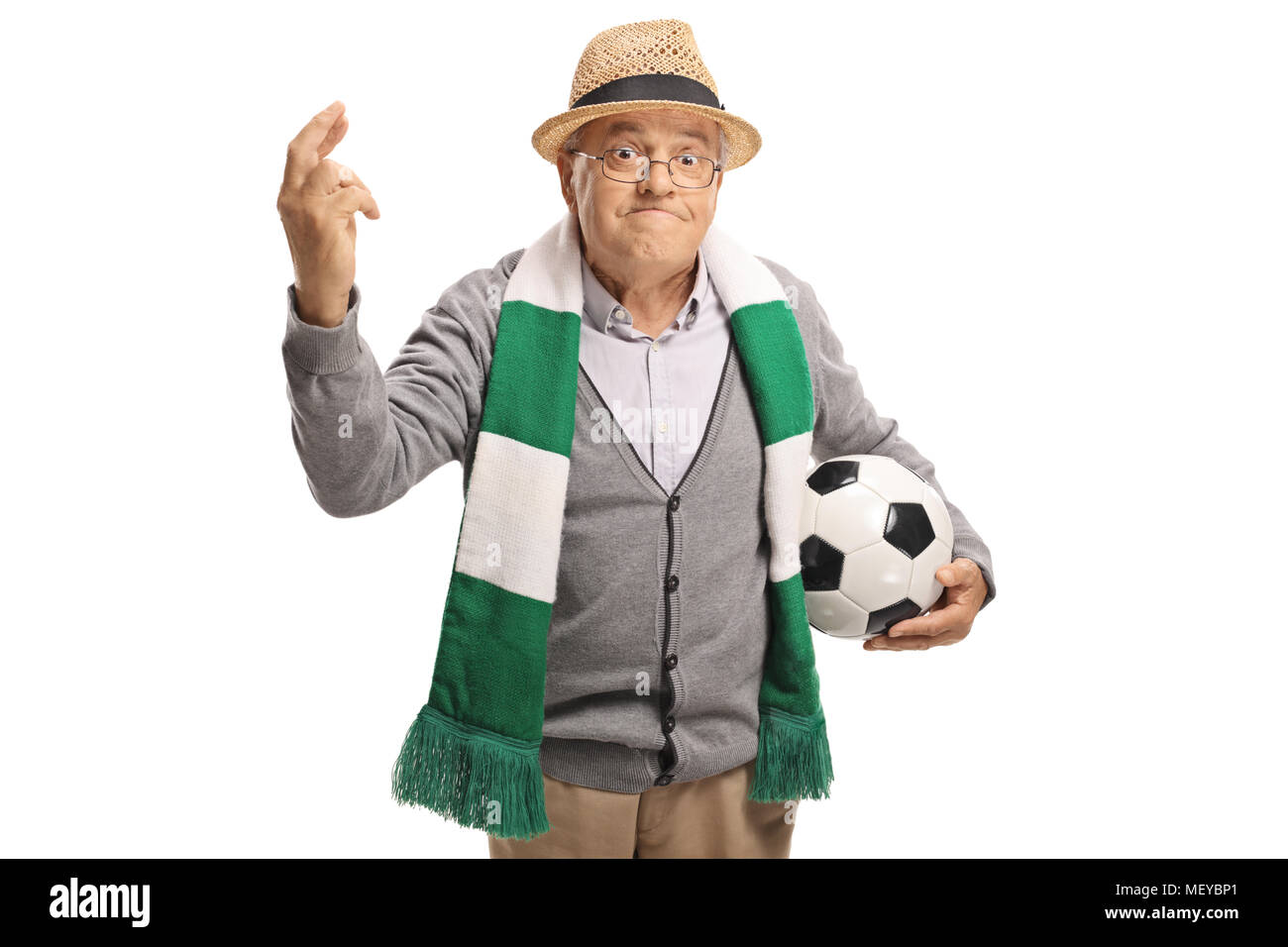 Elderly soccer fan with a football and a scarf holding his fingers crossed for luck isolated on white background Stock Photo