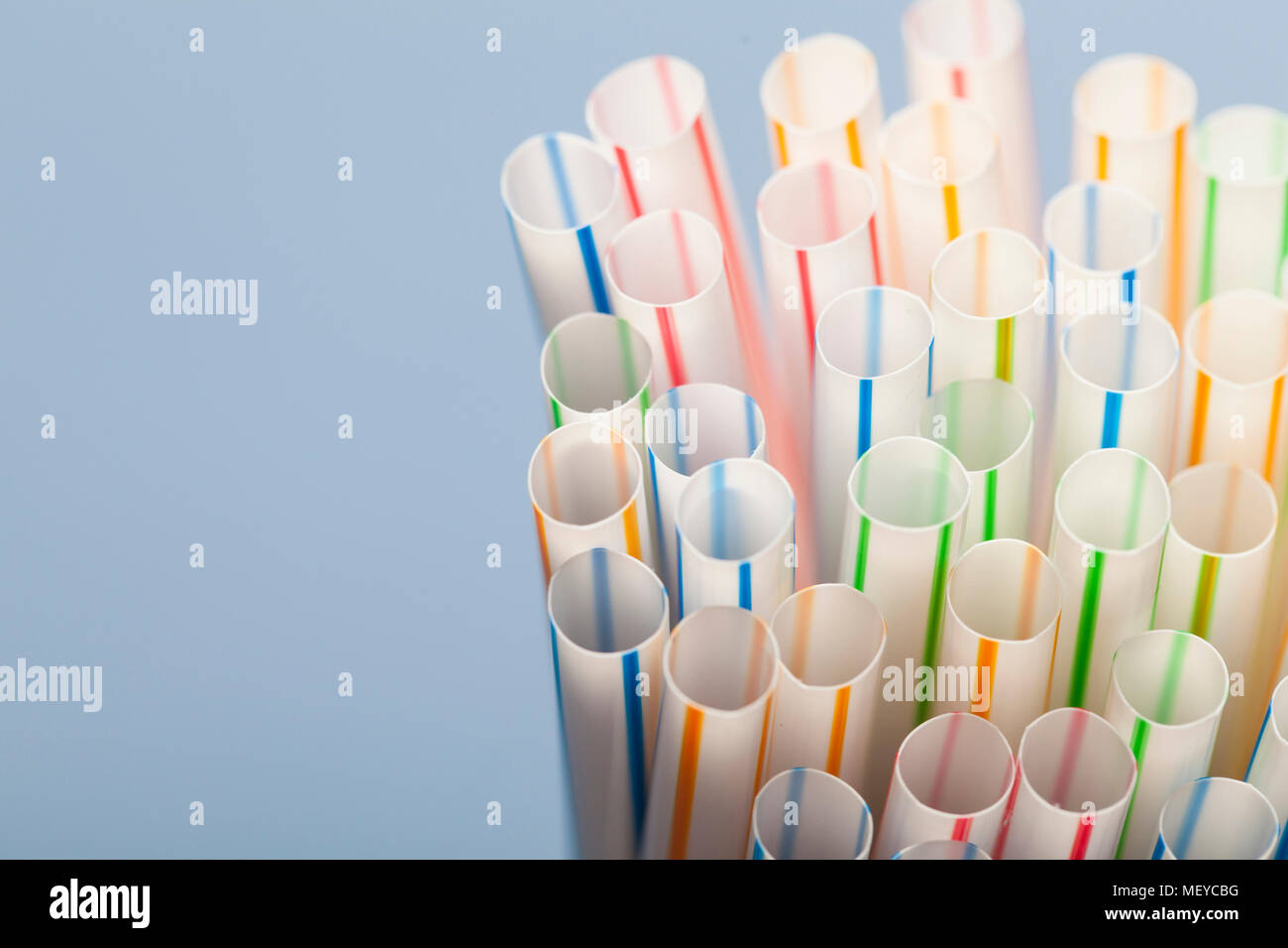 Plastic straws on a blue background Stock Photo Alamy