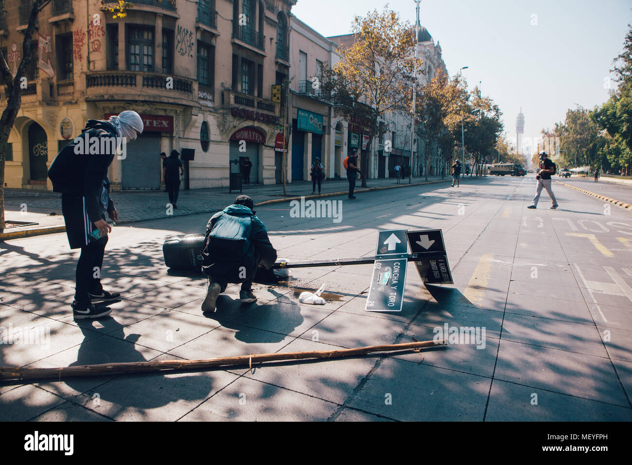 Santiago, Chile - April 19, 2018: A group of protesters causing damage on the street during a demonstration demanding an end to the Profit in the Educ Stock Photo