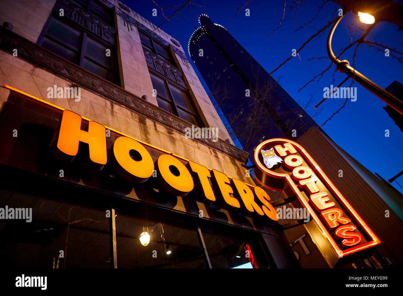 Atlanta capital of the U.S. state of Georgia, Exterior of Hooters bar neon sign outside their Downtown Peachtree restaurant at night Stock Photo
