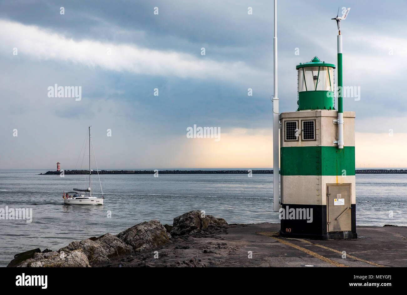 Sailboat enters the port of Ijmuiden, in North Holland, Netherlands, Stock Photo