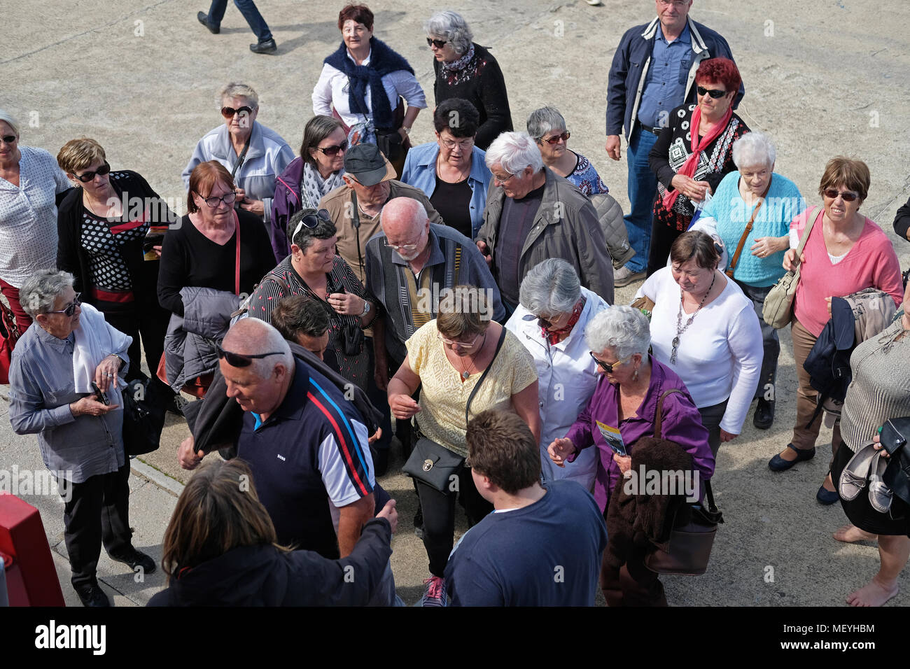 A retired group of tourists about to board a boat. Stock Photo