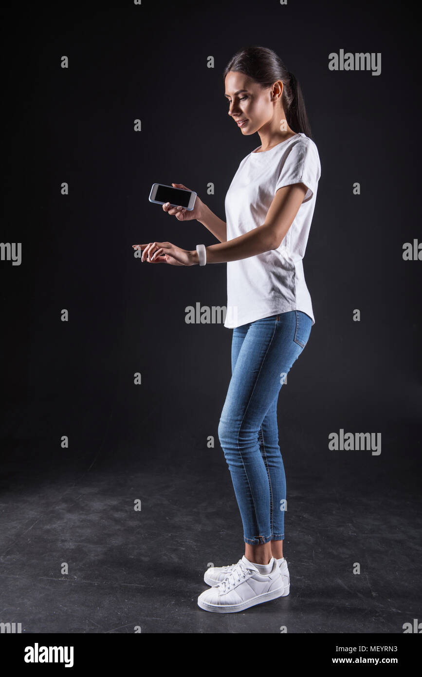 Pleasant serious woman typing Stock Photo - Alamy