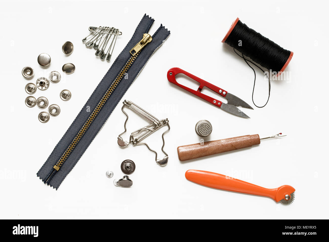 Belt buckles and rivets and metal sewing accessories on white Stock