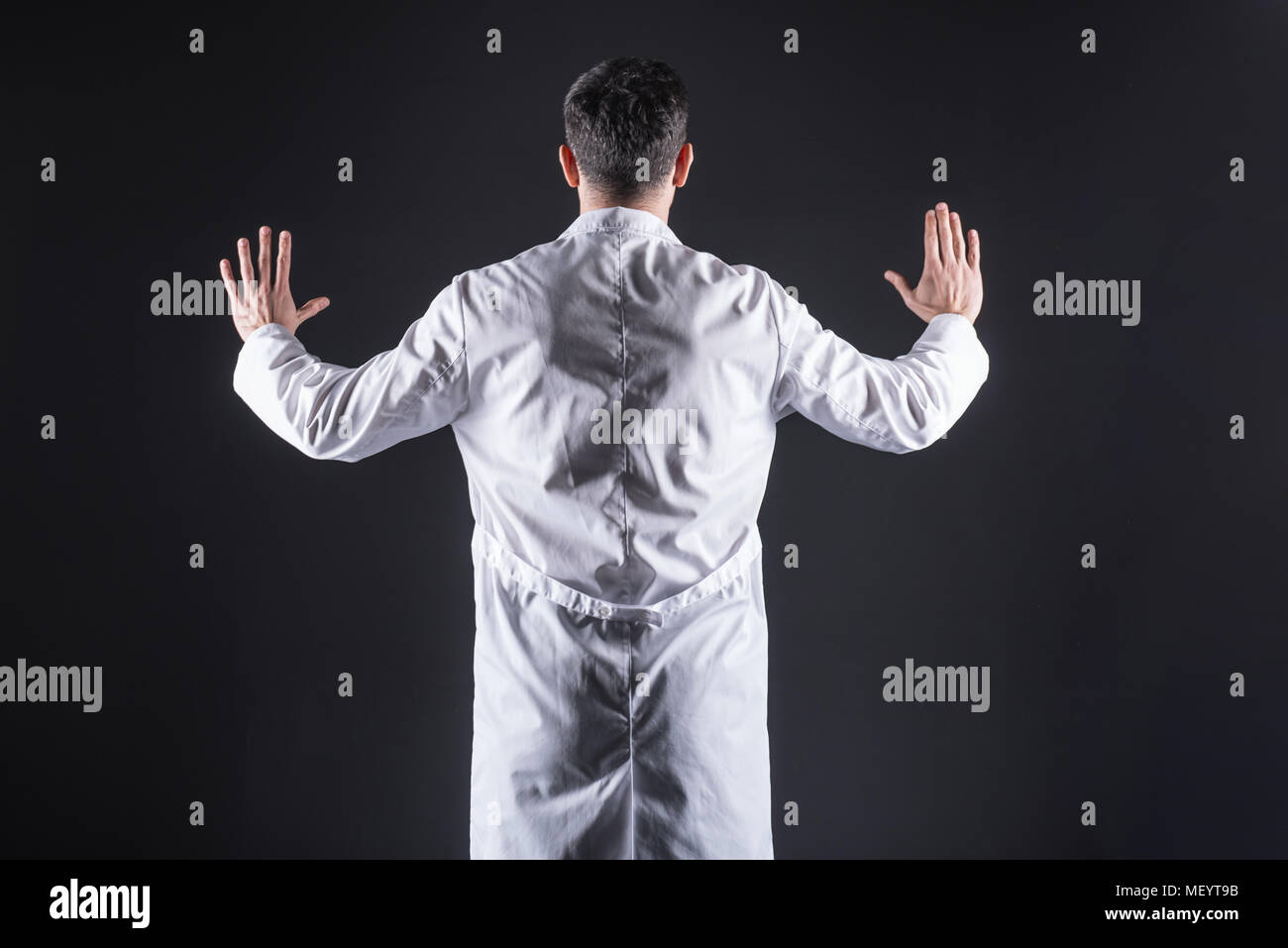 Smart nice scientist pressing his hands to a digital monitor Stock Photo