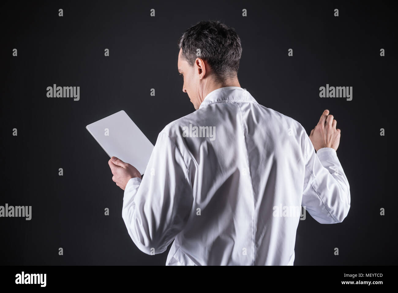 Smart male scientist looking at the tablet screen Stock Photo