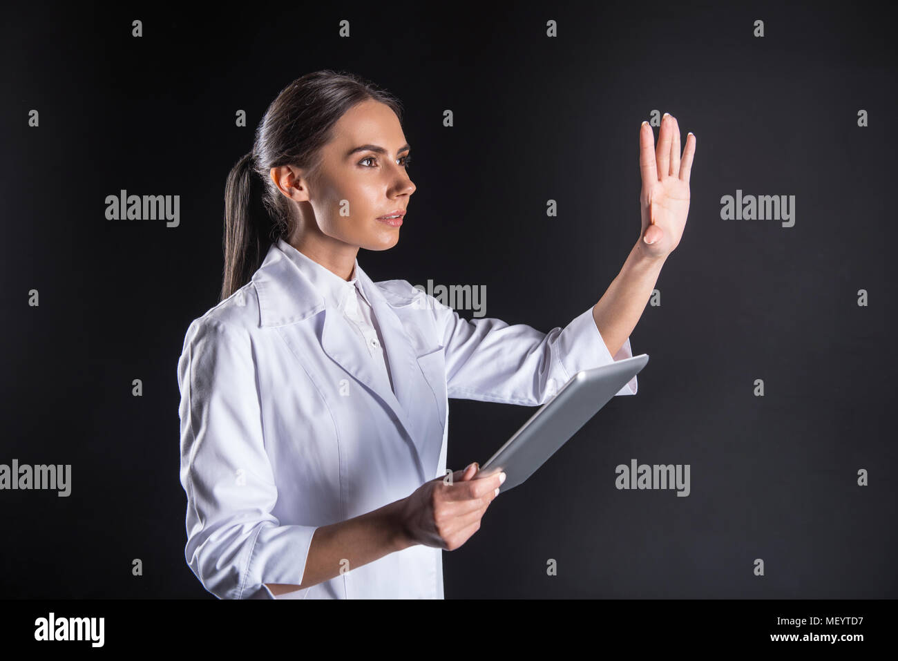 Smart intelligent scientist holding a tablet Stock Photo