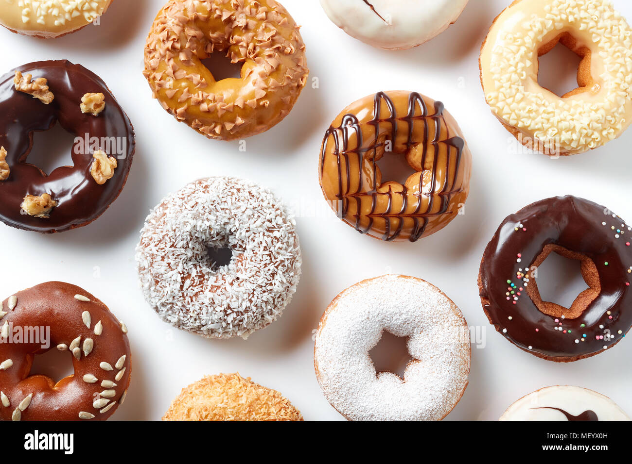 Various colorful donuts isolated on white background, top view Stock ...