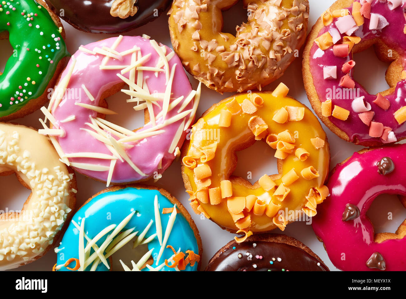 Various colorful donuts on white background, top view Stock Photo - Alamy