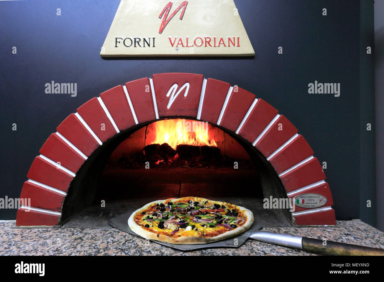 Cheese and Pepperoni Sausage Pizza in a traditional pizza oven Stock Photo